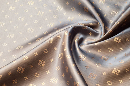 棕色丝绸面料.抽象背景的豪华面料或液体波浪或波浪折痕.