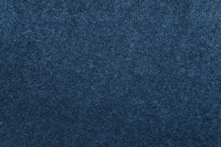 一个抽象背景或墙纸的蓝色靛蓝天鹅绒织物的宏观纹理