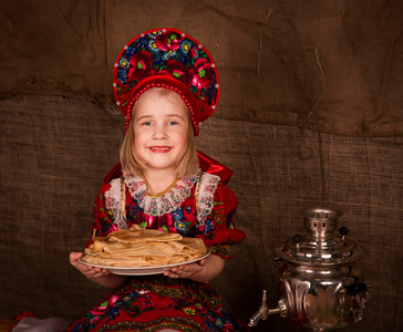美丽的俄罗斯姑娘与满盘的煎饼