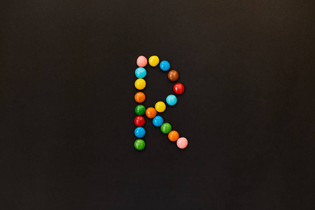 用彩色糖果做的英文字母表。字母 R