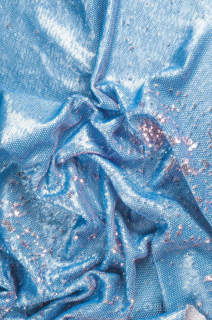 纹理背景图案丝绸布的蓝色绣有亮片闪光反射太阳的光芒