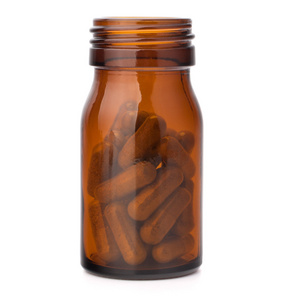 草本药物胶囊在棕色玻璃瓶中。替代医学