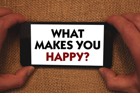 写笔记, 显示什么使你快乐的问题。商业照片展示幸福伴随着爱和积极的生活男人手持手机白屏留言应用程序柳条背景