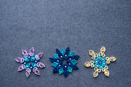 纸 quilling 圣诞工艺品以雪花的形式从纸条。三纸细丝雪花。从纸上手工制作的圣诞装饰品。复制空间