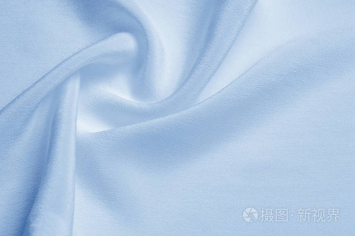 纹理背景图案.蓝色丝绸织品.一个波纹的蓝色丝绸面料特写.广告空间.