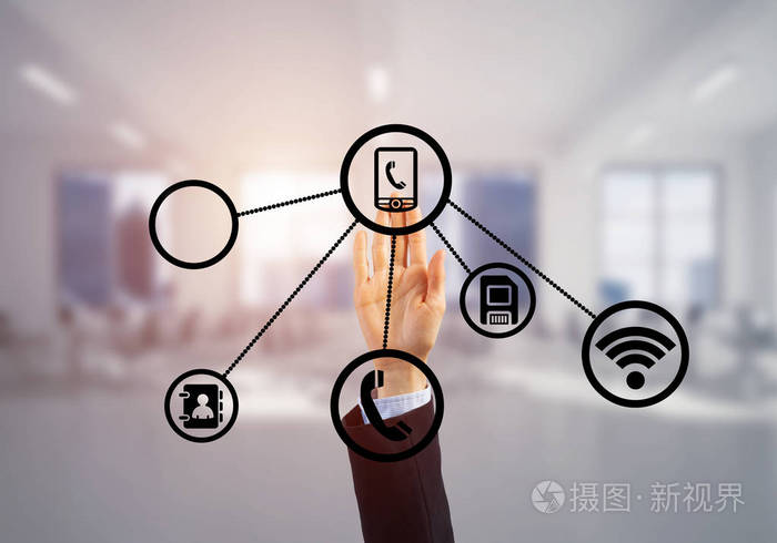 商人手触摸屏幕上的用户面板图标与现代办公室内部背景