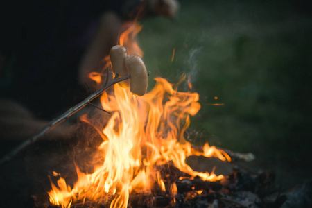在篝火上烤的香肠在自然环境下燃烧