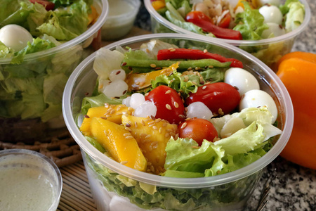 新鲜蔬菜沙拉在一个开放的塑料碗包装