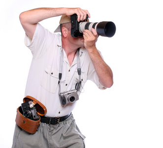 摄影师用相机上 safari 西装穿衣服.工作室拍摄上孤立的白照片