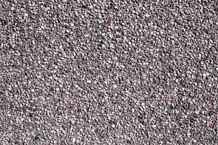 沙墙小砂石的质地或砂墙背景。用于文本或图像复制空间设计的天然粉红色砂石