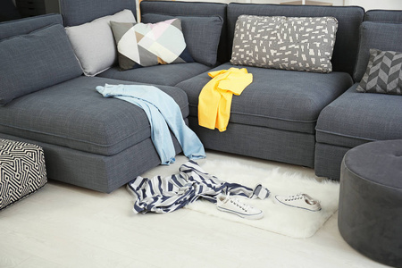 分散地毯散落在起居室里的脏衣服照片