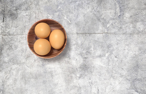 使木碗的鸡蛋。放在混凝土桌上