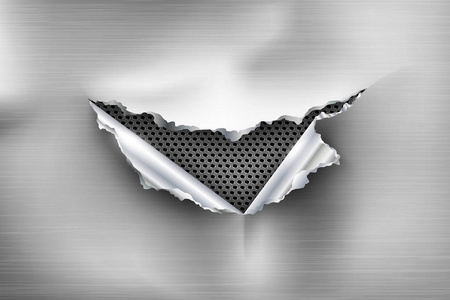 金属背景中撕裂钢的破洞照片