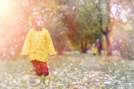 一个穿雨衣的孩子秋天出去散步