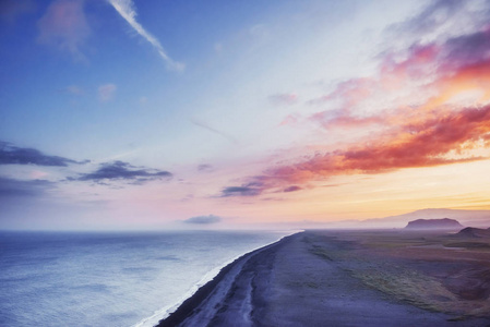 在冰岛的日落时分, 黑色沙滩和山脉 Reynisfjara Reynisfyal 从海角。