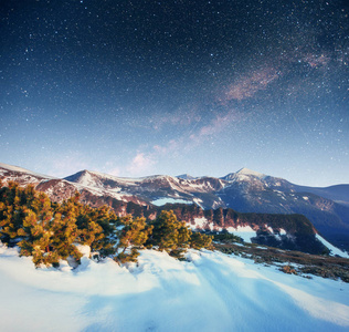 在冬雪的夜空中繁星闪烁。梦幻般的银河在除夕夜