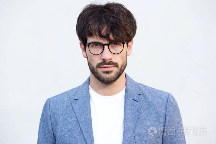 关闭肖像英俊的年轻男子与胡子和眼镜对白色背景