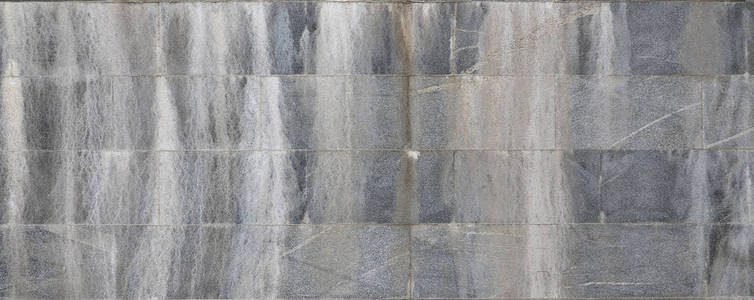 旧灰色花岗岩砖墙的背景纹理