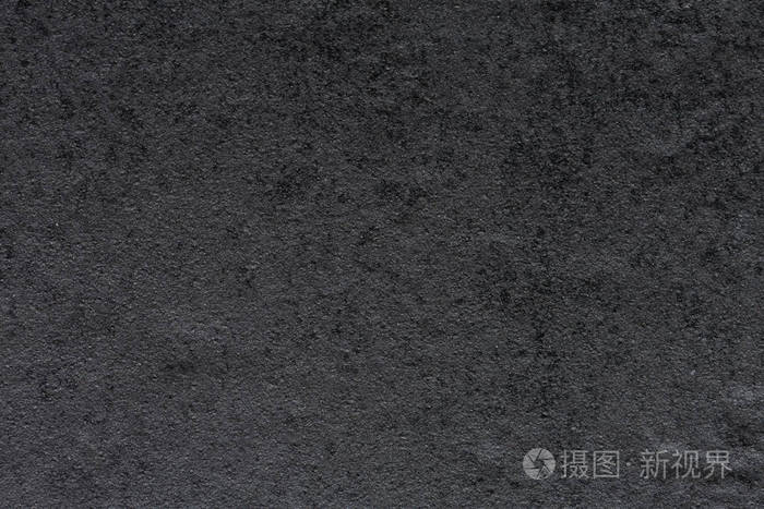 深灰色色调中的严格合成石材背景