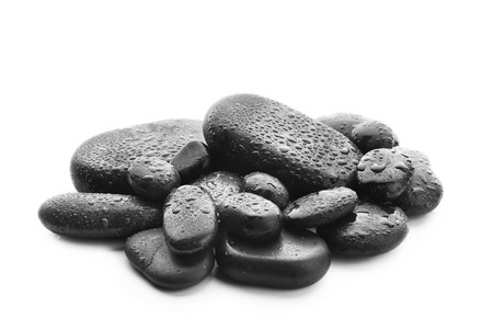 白色背景下滴水的温泉石照片