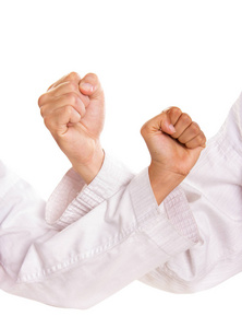 两个握紧的拳头交叉.武术的概念.特写肖像被隔离在白色背景上照片