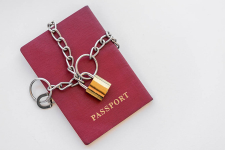 红色护照包裹在一个白色背景的金色锁链。孤立