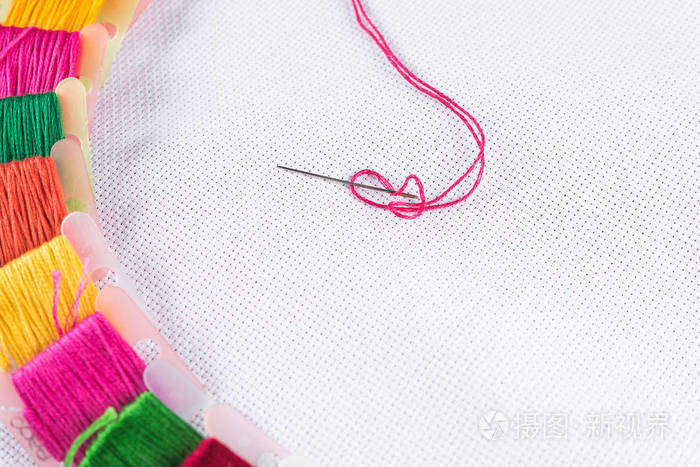 白色帆布上绣的彩色线一根红色线针复制spase