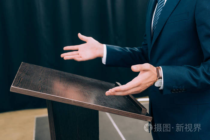 会议大厅讲座中讲师站立和手势的裁剪图像
