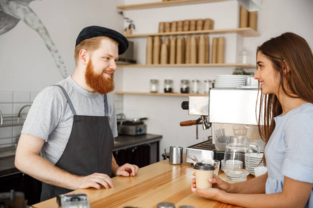 咖啡商业概念年轻的长胡子英俊的咖啡馆与美丽的白种顾客谈话在现代咖啡馆里