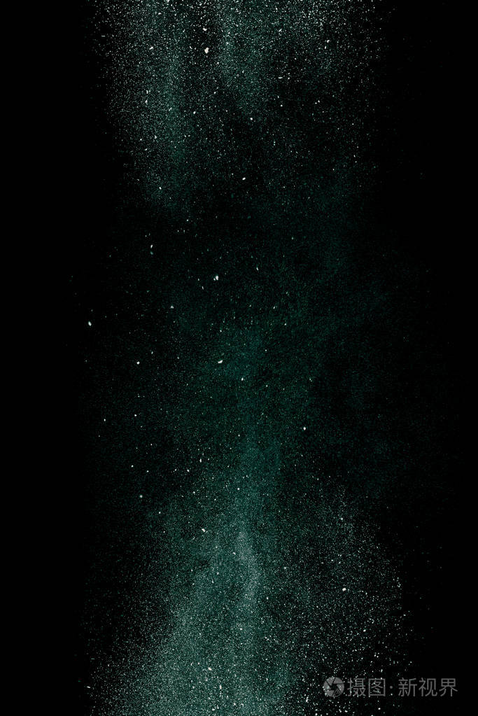 黑色背景上的绿色尘埃运动中的细颗粒