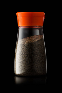 混合盐和胡椒的塑料振动筛, 分离在黑色 bac