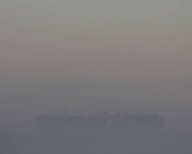 非常高的建筑起重机在早晨的雾, 对灰色天空背景特写