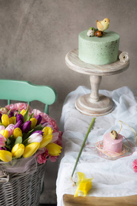 复活节餐桌装饰, 美味的自制蛋糕与春天的花朵和彩绘鸡蛋在假日餐桌上。篮子新鲜安置接近复活节桌
