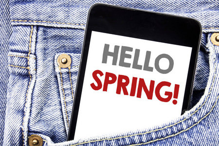 写文字显示你好春天。夏季时间的商业概念欢迎写在手机手机智能手机在男子口袋里