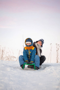 两个快乐的男孩，在冬季户外的雪橇