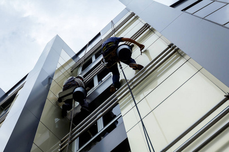 一队登山工在工作, 他们正在洗建筑门面