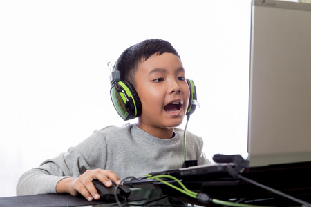 亚洲孩子玩电脑游戏和聊天的朋友