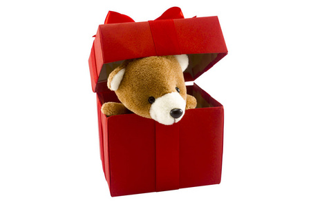 可爱的泰迪熊在红色礼品盒孤立的白色背景机智