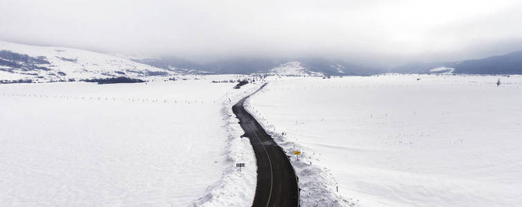漫长的道路延伸穿过积雪的风景, 鸟瞰图