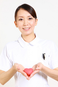 Young Japanese nurse with heart