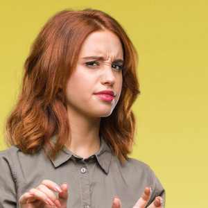 年轻美丽的女人在孤立的背景下反感表达, 不高兴和害怕做厌恶的脸