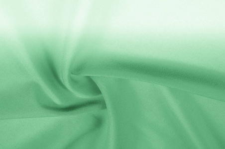 背景纹理, 图案。丝绸面料是绿色的苍白。在时尚的顶部打扮你的决定在最新的设计为您的网页叠加层套装
