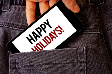 概念手写显示快乐假期的动机呼叫。商务照片展示问候庆祝节日男子手持手机白色屏幕字母牛仔裤口袋