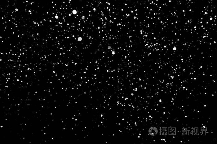 暴风雪的纹理在黑色背景上的散景灯拍摄的飞片雪花在空中