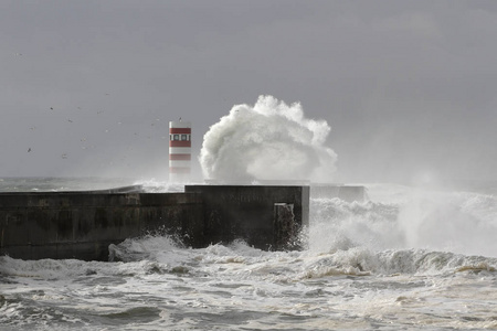 海浪飞溅。杜罗河河口南码头和灯塔, 波尔图, 葡萄牙