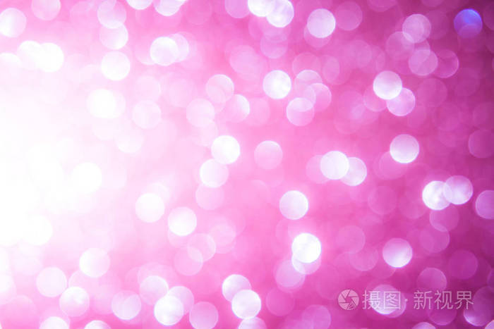 粉红色模糊抽象背景。散景圣诞节模糊美丽闪亮的圣诞灯
