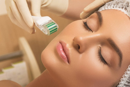 美丽的女人在美容院期间 mesotherapy 程序。中细辊面 microneedling 处理