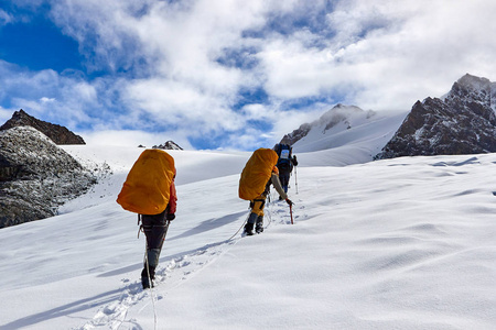 一群登山运动员爬上雪山山顶。