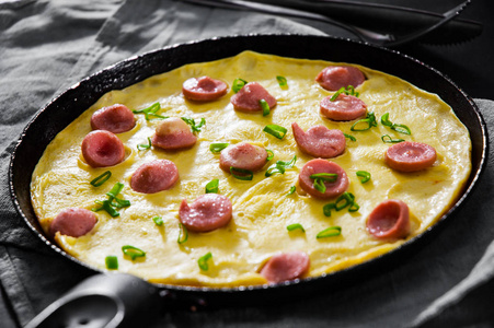 煎鸡蛋煎蛋用香肠煎锅在木桌上照片