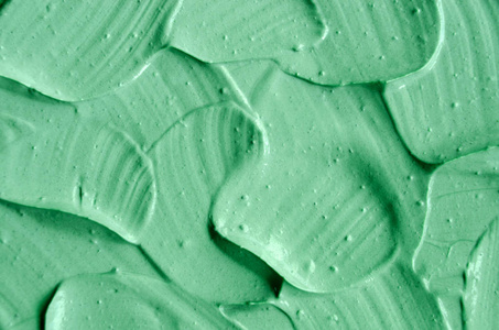 绿色化妆品粘土 面膜, 奶油, 身体磨砂 纹理特写, 选择性对焦。具有画笔描边的抽象背景